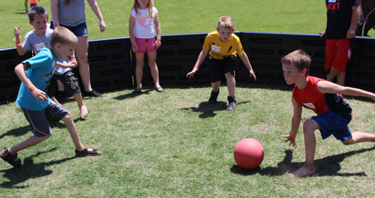 Kids playing Gaga Ball on grass