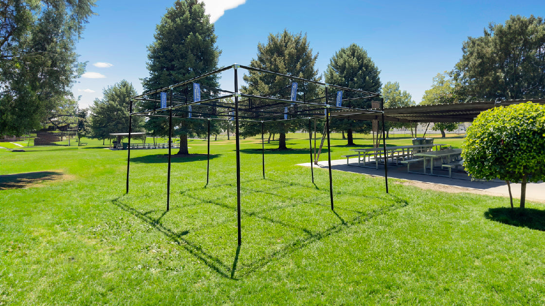 black poles and black nets permanent 9 square set on grass. 