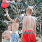 Guys hitting a red 9 Square ball while splash pad is active